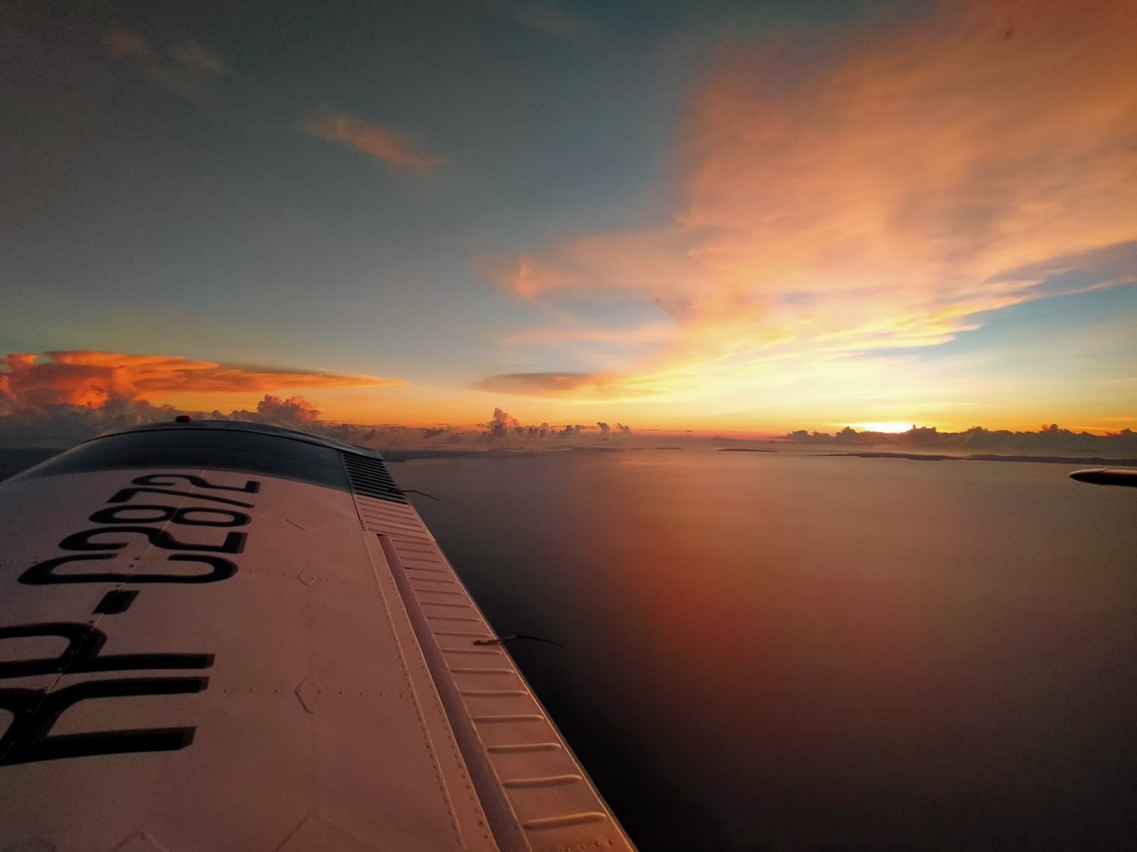 Cessna RP-C2872 wing at sunset — Senior FO over Philippine waters