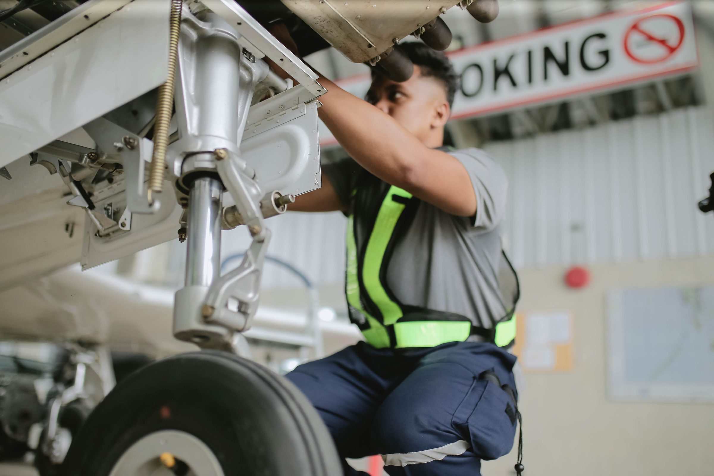 CAFS maintenance technician inspecting landing gear — hangar safety discipline