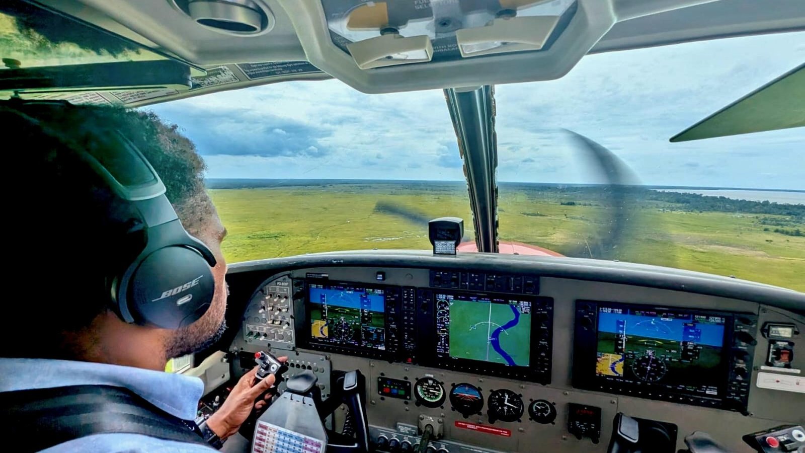 Capt. Rick Poki at the controls of a MAF Cessna 208 Caravan over Papua New Guinea — CAFS alumnus